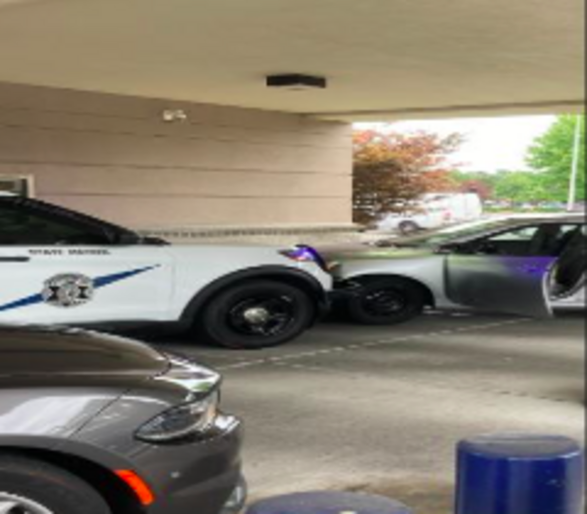 This image provided by the Washington State Patrol shows troopers blocking a suspect from fleeing the Heritage Bank ATM drive-thru in Auburn on Friday, after an earlier alleged incident that started near Vancouver, Washington, on Interstate 5.