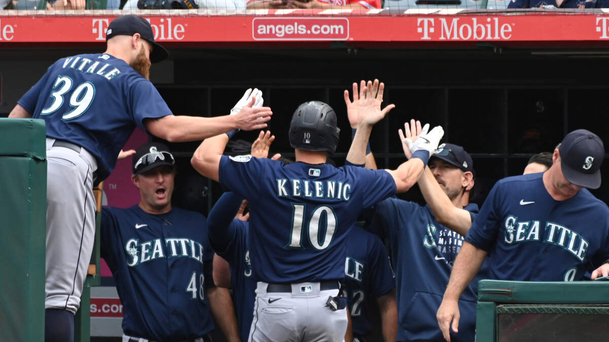 Seattle Mariners’ Jarred Kelenic (10) is congratulated in the dugout after hitting a solo home run in the seventh inning of a baseball game against the Seattle Mariners, Sunday, Sept. 26, 2021, in Anaheim, Calif. (AP Photo/Michael Owen Baker)