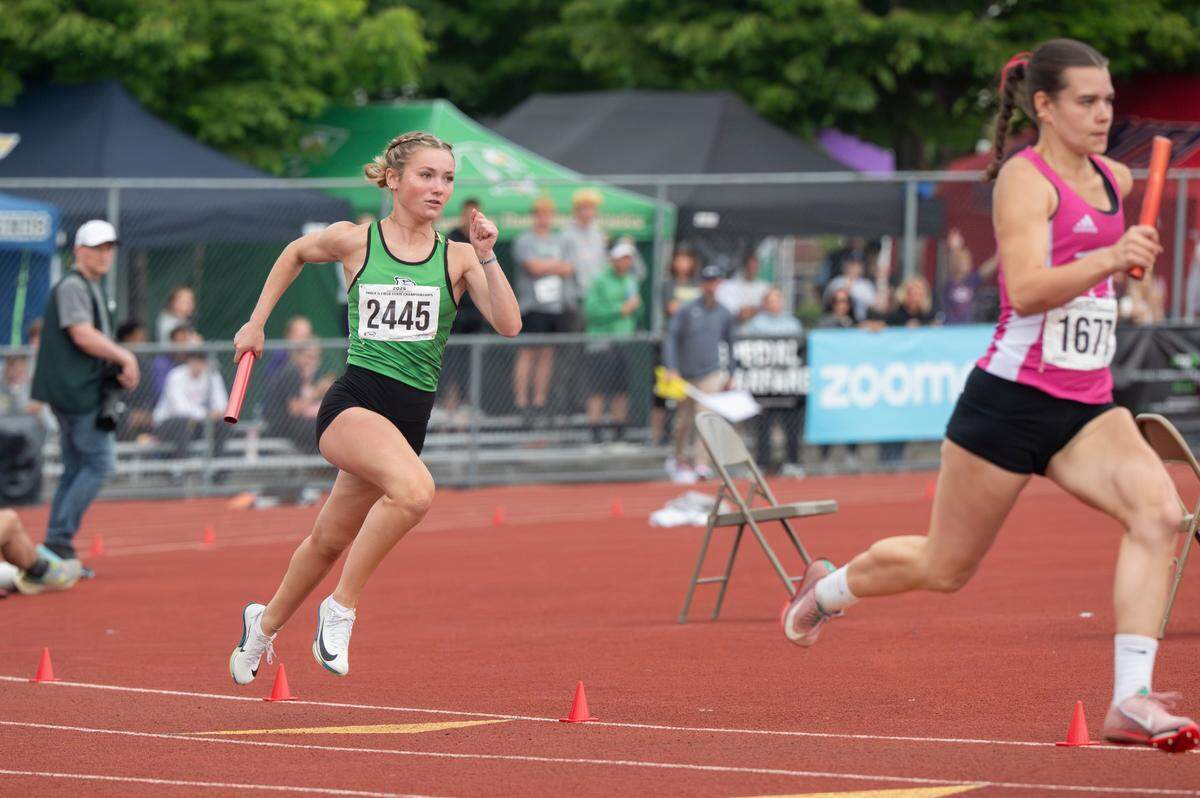 Tumwater’s Cassidy Hedin, left, carries the baton for her leg of the 2A girls 4x200 relay final on Saturday, May 31, 2025, during the 2025 WIAA Track & Field Championships at Mount Tahoma High School in Tacoma, Wash. Tumwater took first place with a time of 1:42.24.