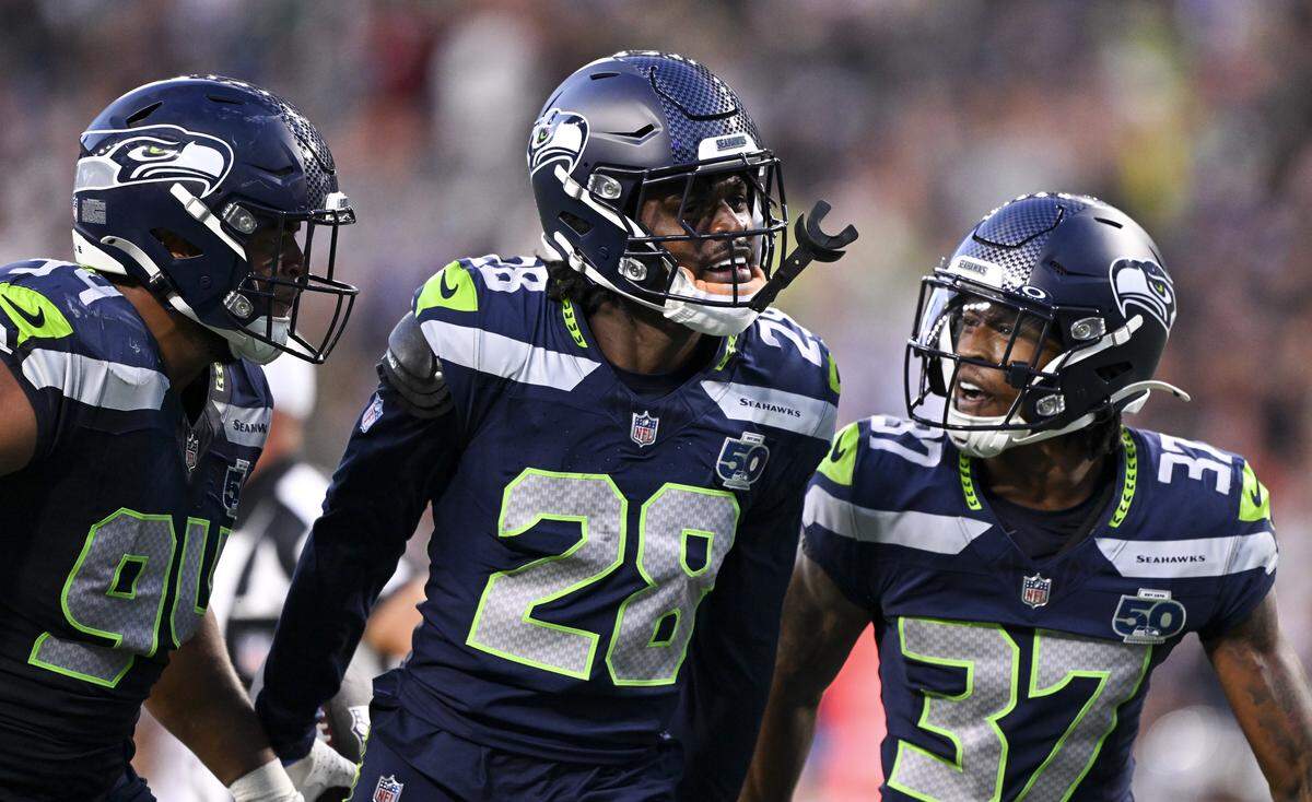 Seattle Seahawks cornerback Nehemiah Pritchett (28) celebrates a interception against Las Vegas Raiders quarterback Aidan O'Connell (12) during the second quarter of the game at Lumen Field, on Thursday, Aug. 7, 2025, in Seattle, Wash.
