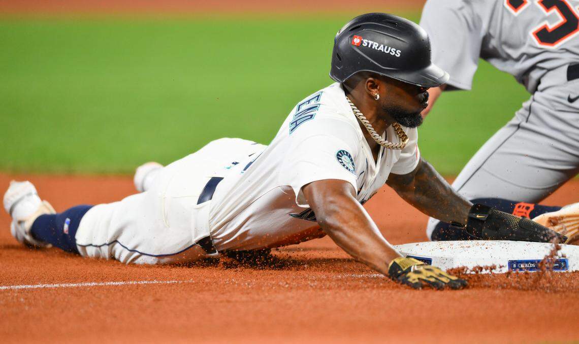 Oct 4, 2025; Seattle, Washington, USA; Seattle Mariners outfielder Randy Arozarena (56) slides into third on a single hit by catcher Cal Raleigh (29) in the sixth inning against the Detroit Tigers during game one of the ALDS round for the 2025 MLB playoffs at T-Mobile Park. Mandatory Credit: Steven Bisig-Imagn Images