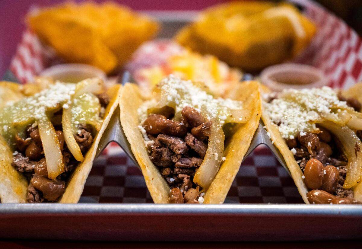 One of several specialties at Los Tapatios in Fircrest, the Tacos Las Vegas feature carne asada, pinto beans, caramelized onions and avocado salsa inside tortillas in a dip of seasoned oil.