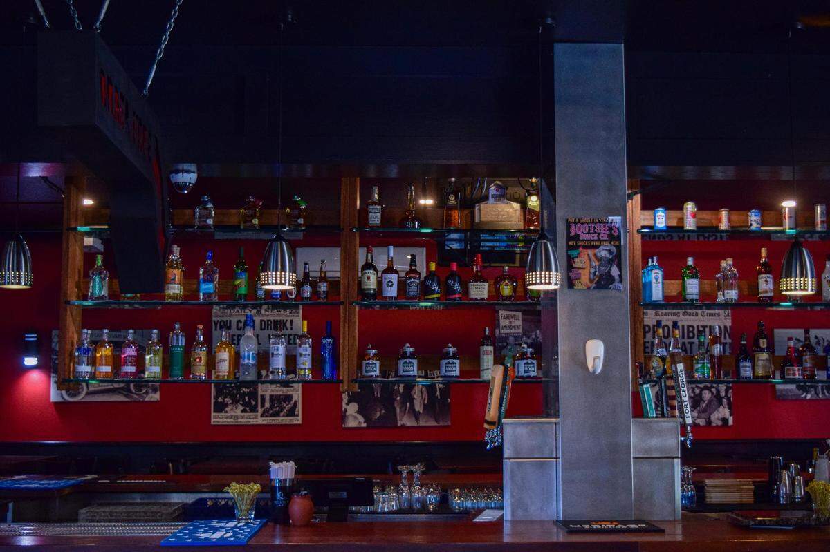 About half of the ceiling drywall was replaced after the fire, and everything has been freshly painted. The main wall of the bar is back to its original 2008-era red.