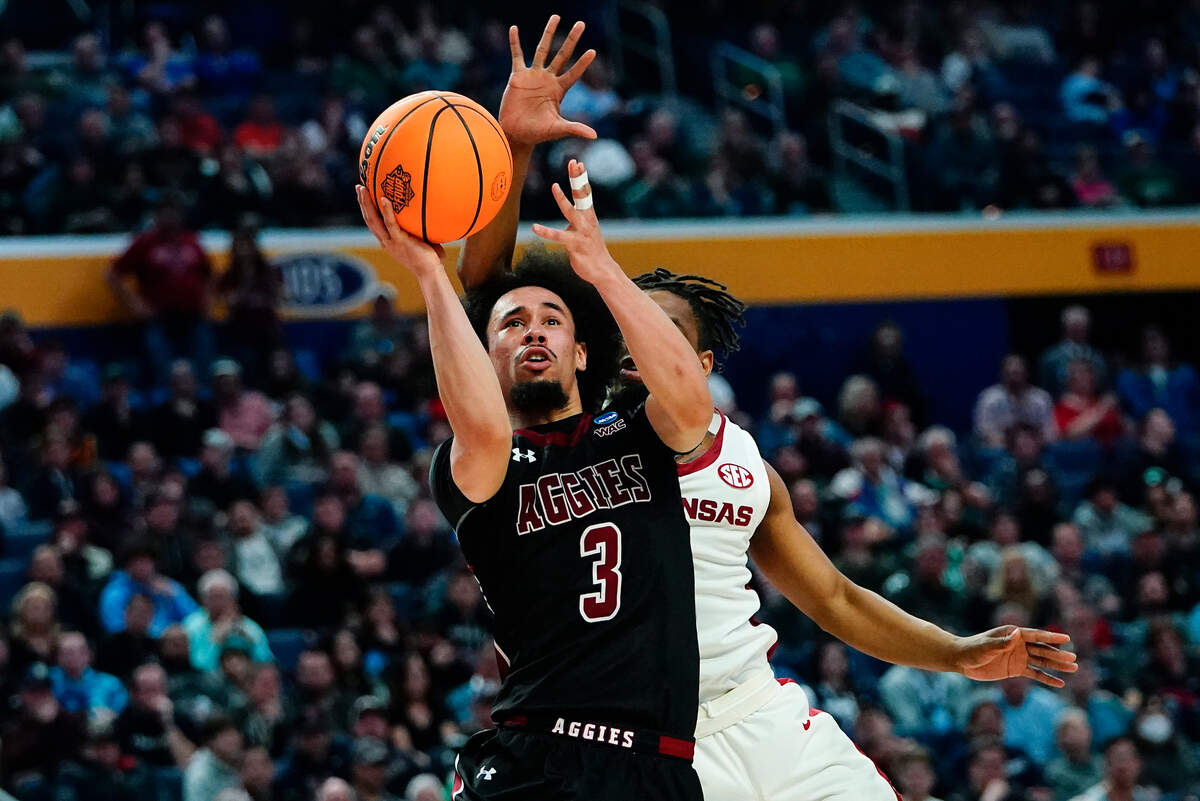 New Mexico State guard Nate Pryor (3) shoots against Arkansas guard JD Notae during the second half of a college basketball game in the second round of the NCAA men’s tournament Saturday, March 19, 2022, in Buffalo, N.Y. (AP Photo/Frank Franklin II)