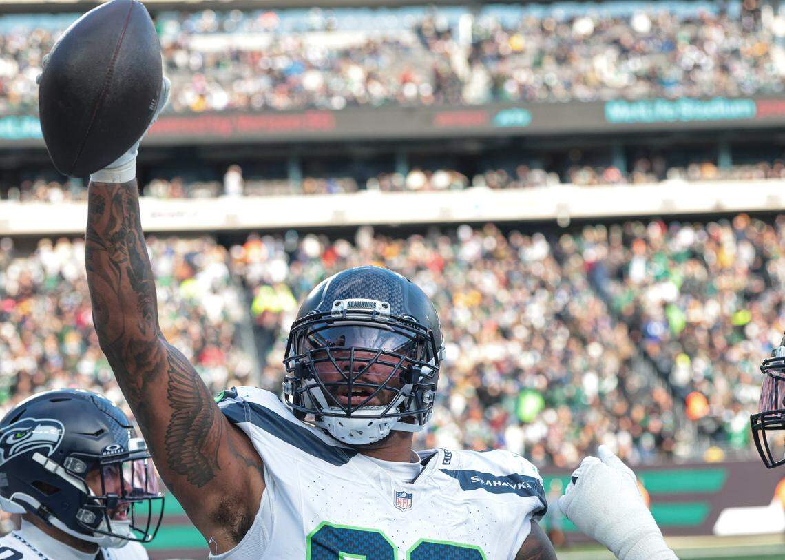 Seattle Seahawks defensive end Leonard Williams (99) celebrates his fumble return for a touchdown during the first half against the New York Jets at MetLife Stadium. Mandatory Credit: Vincent Carchietta-Imagn Images