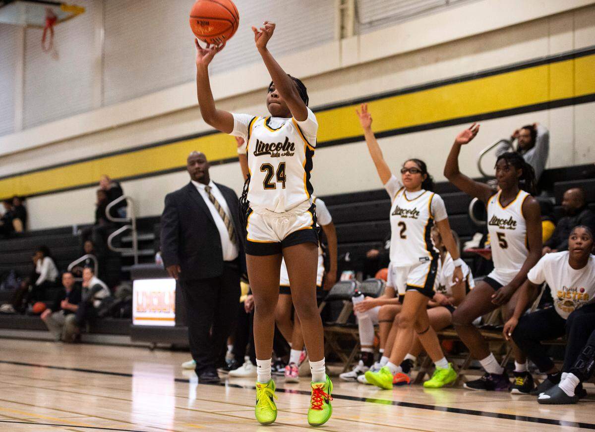 Lincoln guard Malani Warren (24) shoots a three-point shot during a first round Class 3A West Central/Southwest district tournament game against Todd Beamer at Lincoln High School in Tacoma, Wash. on Feb. 10, 2023. Lincoln defeated Todd Beamer 55-28.