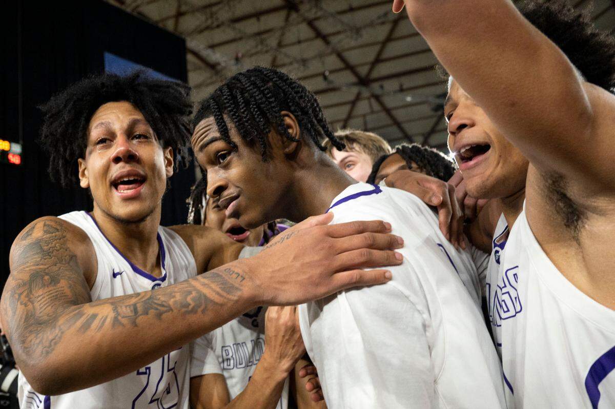 Garfield players hug guard Legend Smiley (13) as they celebrate beating O’Dea, 69-50, to win the Class 3A championship game on Saturday, March 4, 2023, in Tacoma, Wash. Smiley led all scorers with 30 points.