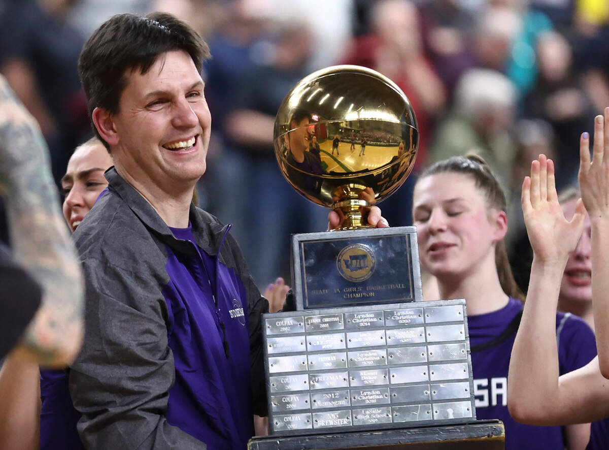 Nooksack Valley coach Shane Wichers lifts the Class 1A state trophy on Saturday, March 4, 2023 at the Yakima Valley SunDome in Yakima, Wash.