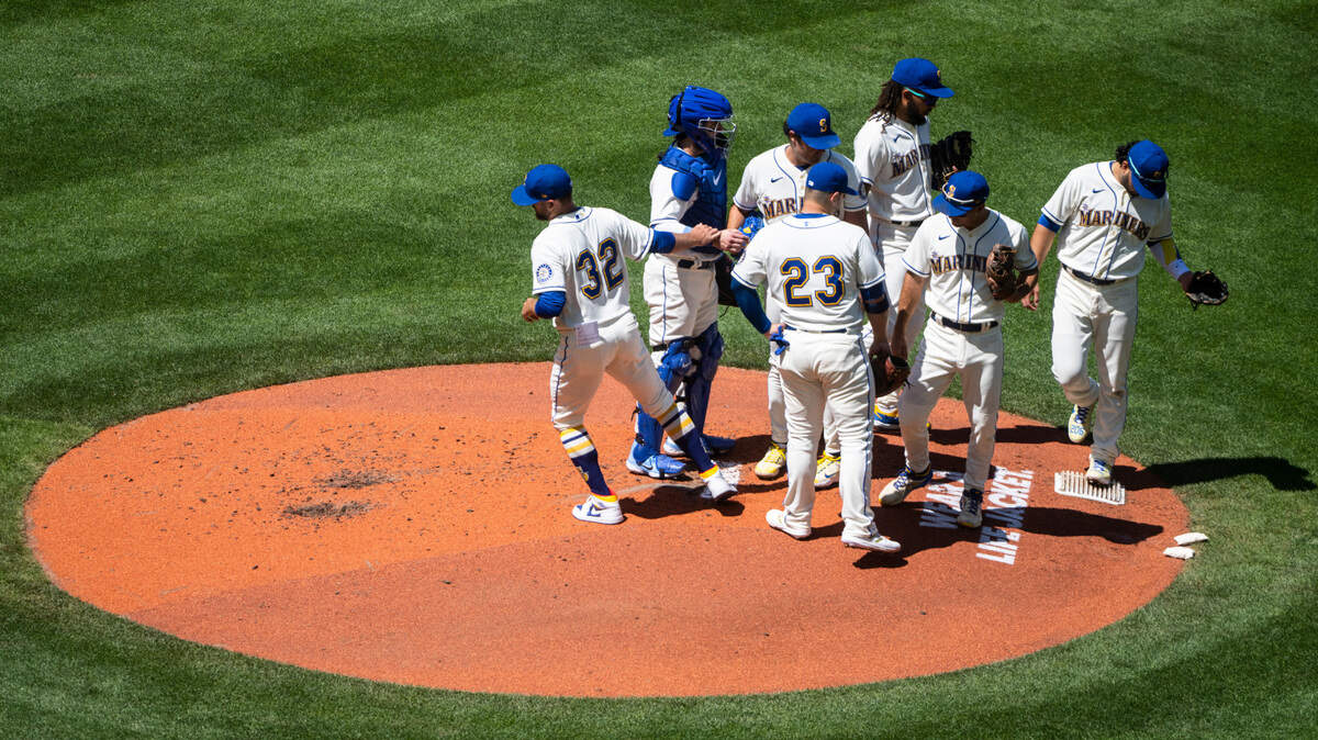 Seattle Mariners players gather on the pitchers mound during the second inning of the game at T-Mobile Park on Sunday, July 24, 2022 in Seattle, Wash.