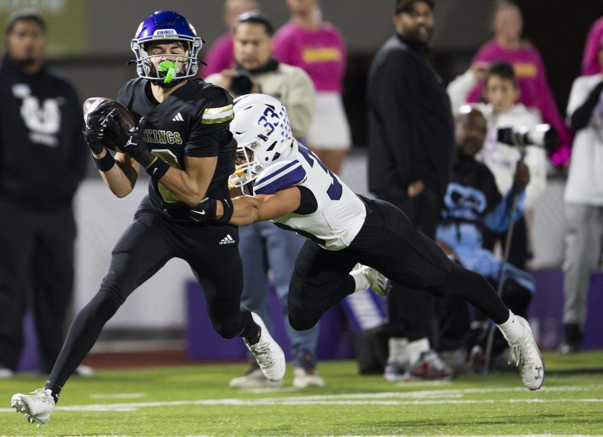 Puyallup wide receiver Lawson Looker (3) makes a catch against Sumner outside linebacker Mason Ota (33) during the first half of the game at Sparks Stadium, on Saturday, Oct. 4, 2025, in Puyallup, Wash.