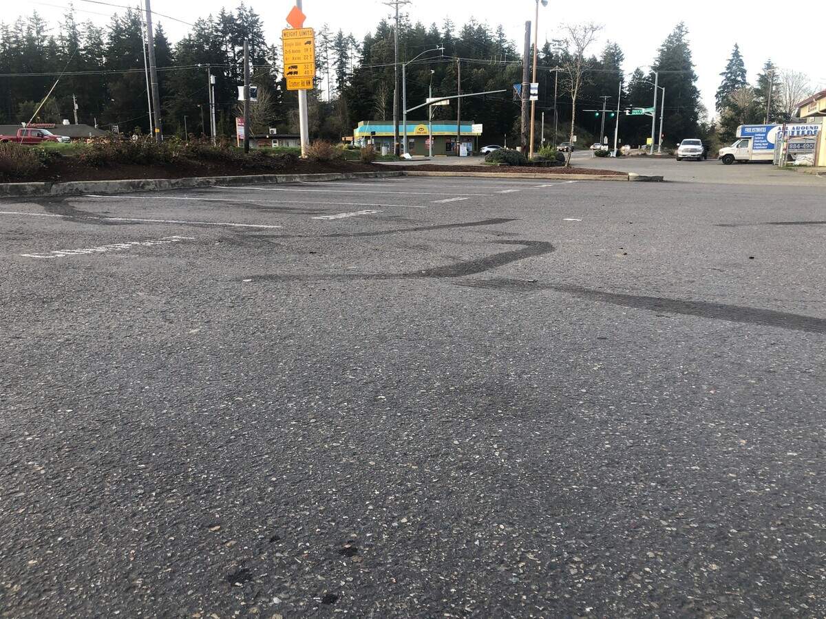 Skid marks in the Key IGA parking lot in Key Center, Wash., on Friday, April 4, 2025, after a pickup truck sped into the lot and engaged in a brief armed standoff with U.S. Marshals.