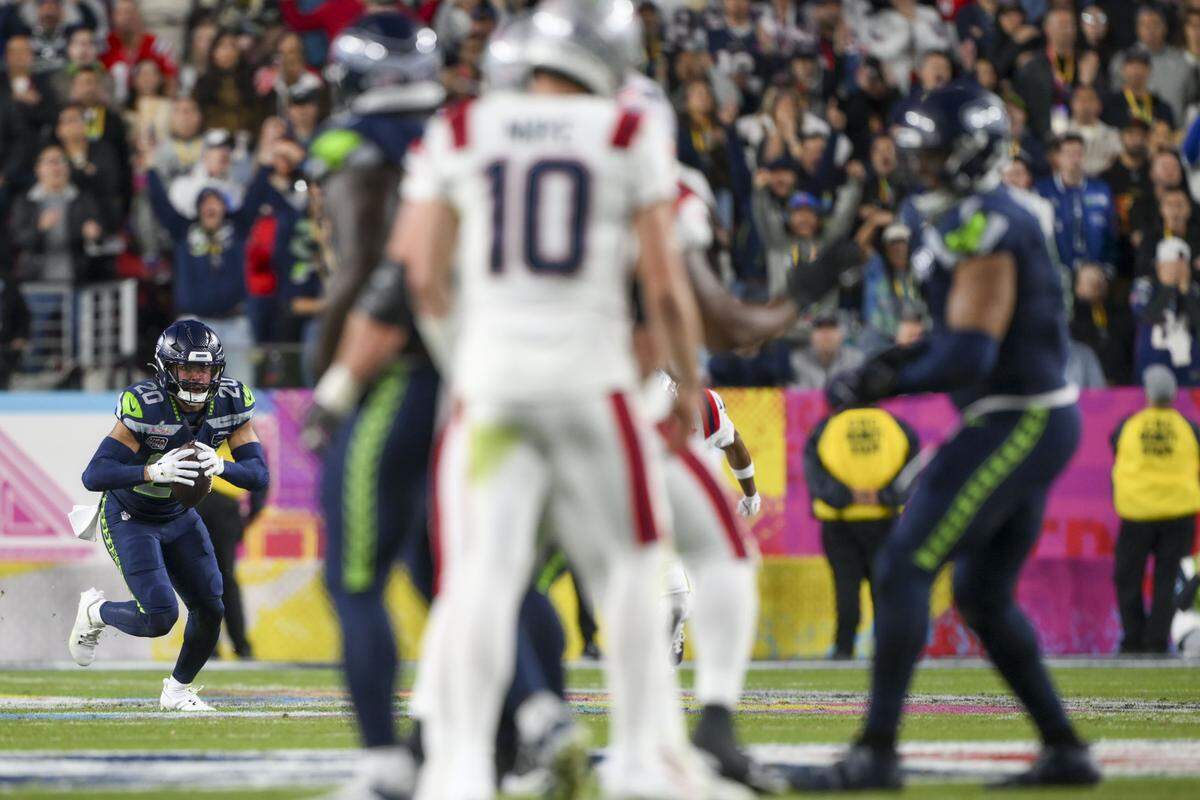 Seattle Seahawks safety Julian Love (20) intercepts a pass from New England Patriots quarterback Drake Maye (10) during the fourth quarter of Super Bowl LX at Levi's Stadium on Feb. 8, 2026 in Santa Clara, Calif.