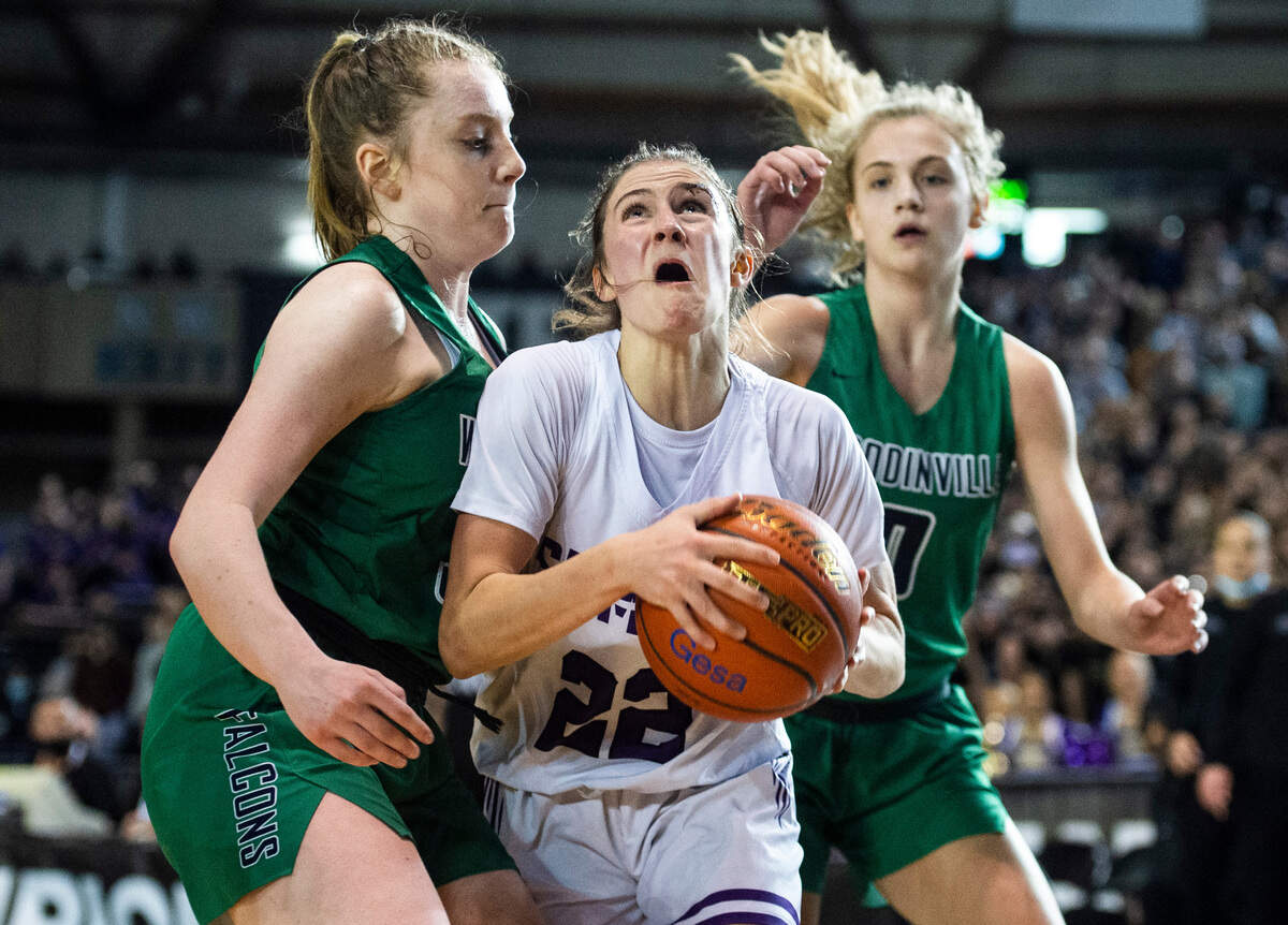 Sumner’s guard Lainee Houilan (22) drives to the basket as Woodinville’s Brooke Beresford (32) defends during the 4A state championship game at Tacoma Dome in Tacoma, Wash. on Saturday, March 5, 2022.