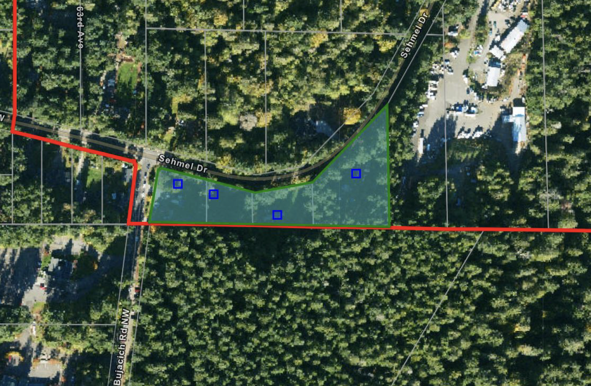An aerial highlighting the site of a proposed commercial site at 6018-6118 Sehmel Drive in Gig Harbor. The development proposes a gas station with convenience store, electric vehicle charging station and a drive-thru coffee stand.
