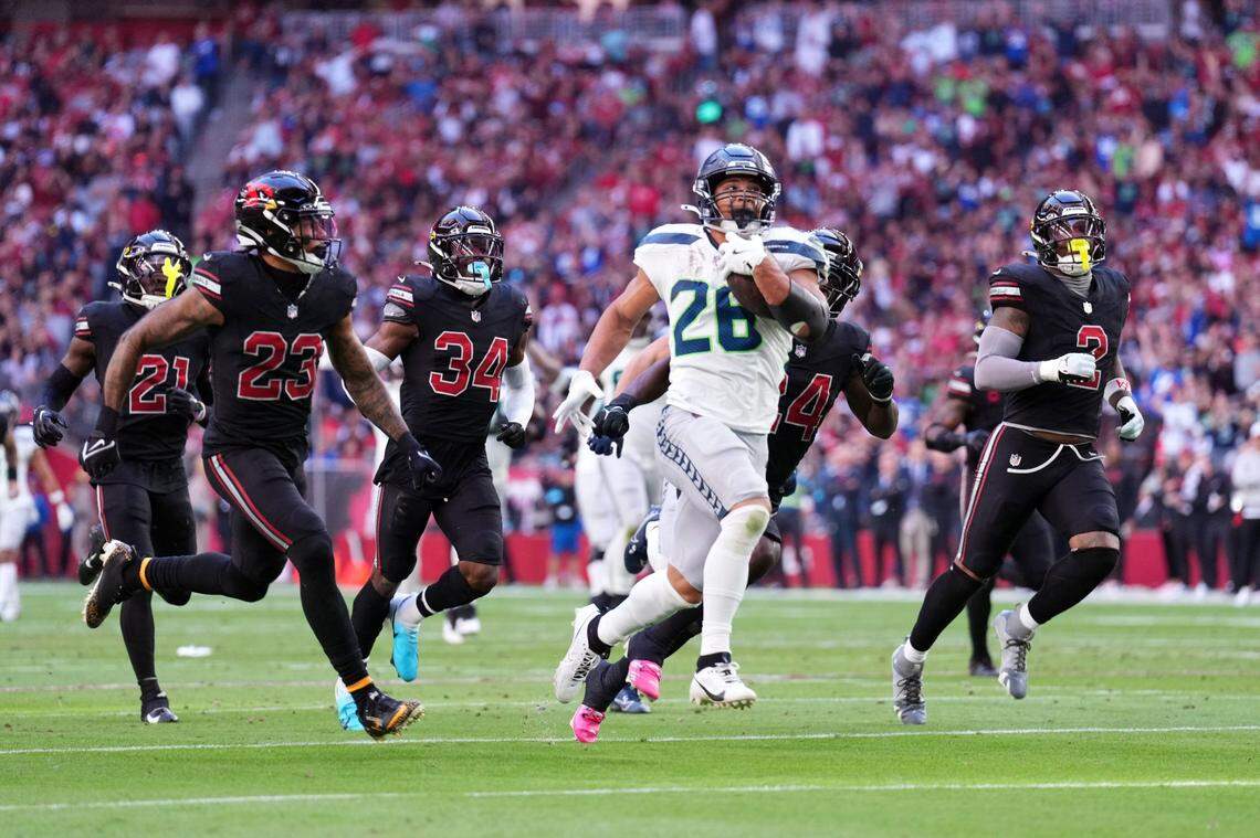 Seattle Seahawks running back Zach Charbonnet (26) runs for a touchdown against the Arizona Cardinals during the first half at State Farm Stadium. Mandatory Credit: Joe Camporeale-Imagn Images
