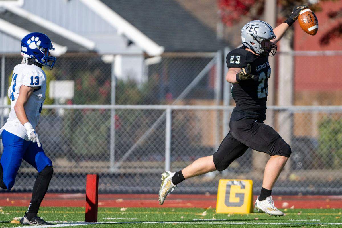 Emerald Ridge running back Logan Lisherness runs into the endzone past Bothell’s Cody Petrin for a touchdown during the first quarter of a Week 10 4A playoff game on Saturday, Nov. 5, 2022, at Sparks Stadium in Puyallup, Wash.