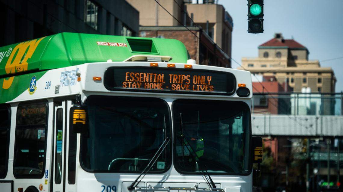 A Pierce Transit bus reads “Essential trips only, stay home-save lives” as it makes a turn in downtown Tacoma, Wash., on Friday, April 17, 2020.
