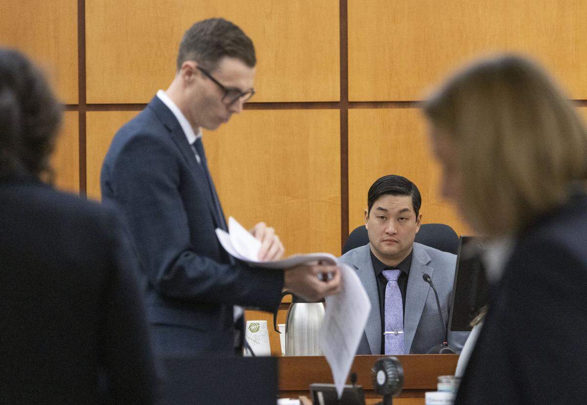 Defense attorney Mark Conrad checks paperwork as defendant Timothy Rankine testifies on Wednesday.