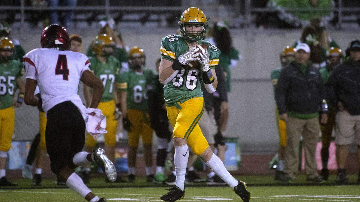 Tumwater tight end Austin Terry pulls in a pass in front of Franklin Pierce defensive back Aaron Swain during Friday night’s opening round game of the 2A state football playoffs at Tumwater District Stadium on Nov. 15, 2019.