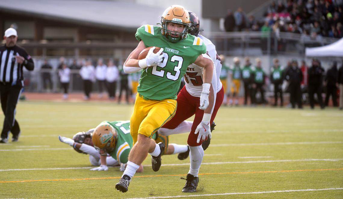 Tumwater running back Cash Short breaks away from Archbishop Murphy defensive lineman Jack Sievers for a touchdown run during Saturday’s 2A state football semifinal game at Tumwater District Stadium in Tumwater, Washington, on Nov. 30, 2024. Tumwater won the game, 42-0, to advance to next weekend’s state championship game at Husky Stadium in Seattle.