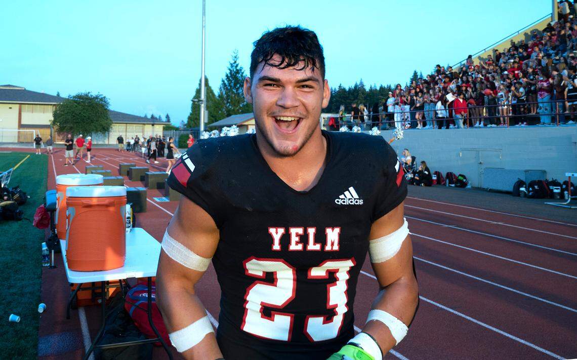 Yelm running back Brayden Platt smiles on the sidelines after scoring the opening touchdown for the Tornados during Friday night’s season-opening football game against the Camas Papermakers at Yelm High School in Yelm, Washington on Friday, Sept. 2, 2022.