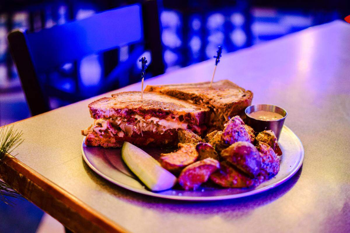 A varied sandwich menu includes a Reuben with house-spiced corned beef and parm-dusted roasted potatoes.
