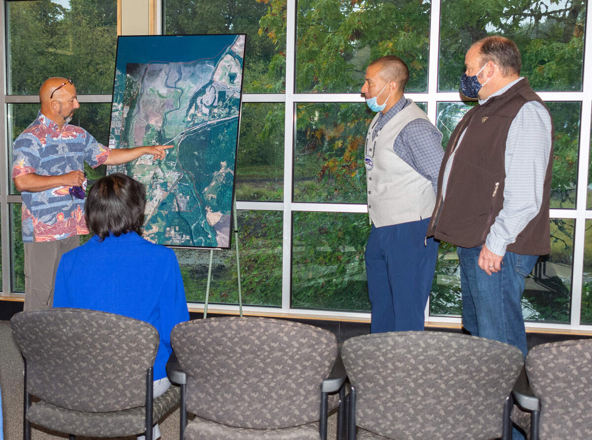 Nisqually Department of Natural Resources Director David Troutt, left, points to a map to discuss concerns for watershed protection and salmon recovery with White House Council on Environmental Quality Chair Brenda Mallory at a meeting with the council and Tribal leaders Oct. 5, 2021, at the Billy Frank Jr. Nisqually National Wildlife Refuge northeast of Olympia. Joined by Nisqually Indian Tribe Chairman Willie Frank III, middle, and Tribal Treasurer David Iyall, right, the team shared with Mallory the multiple ways their Tribe and others are mitigating the effects of climate change.