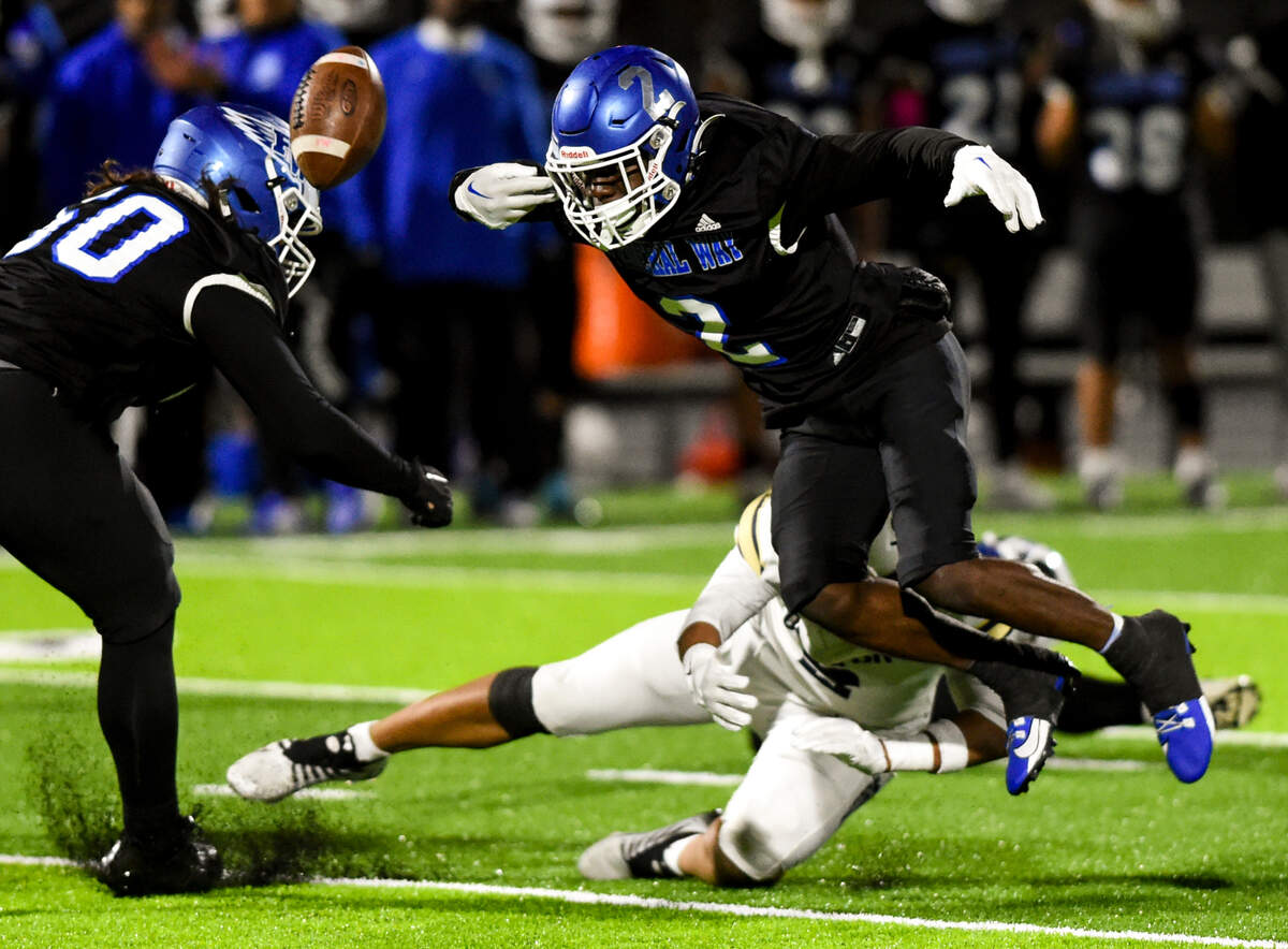 Federal Way’s Zamarie Tellez (2) fumbles the ball on a hit from Decatur’s Jasonni Prum (2) resulting in a turnover during the first half of the game at Federal Way Memorial Stadium, Thursday, Oct. 26, 2023, in Federal Way, Wash.
