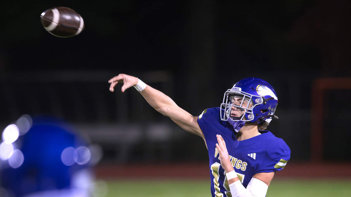 Puyallup quarterback Luke Parker throws a touchdown pass during Friday night’s football game against the Curtis Vikings at Sparks Stadium in Puyallup, Washington, Oct. 25, 2024. Puyallup won the game, 49-35.