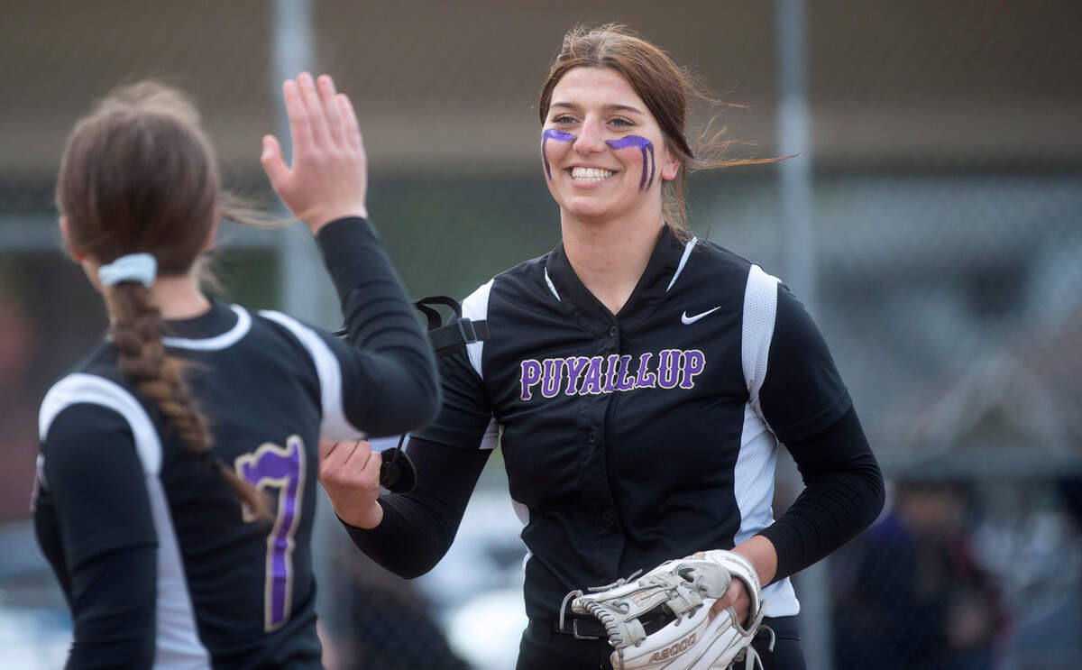 Puyallup pitcher Izzy Welch is congratulated by catcher Sam Bland after a shutout inning against the Sumner Spartans at Puyallup High School in Puyallup, Washington, on Wednesday, April 27, 2022.