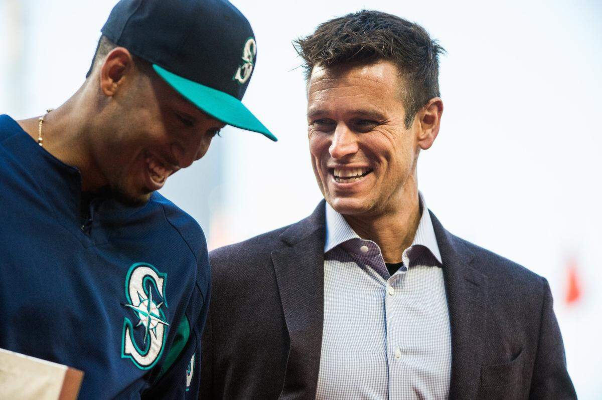 Edwin Diaz and Jerry Dipoto share a laugh as they walk off the field during a pregame ceremony honoring Diaz. The Seattle Mariners played the Los Angeles Angels in a Major League Baseball game at Safeco Field in Seattle, Wash. on Friday, May 4, 2018. 