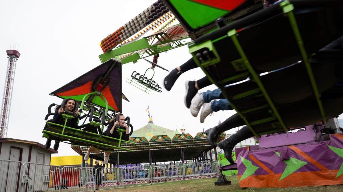 Members of the news media ride the Cliff Hanger at the Washington State Fair, Thursday, Aug. 31, 2023, Puyallup, Wash.