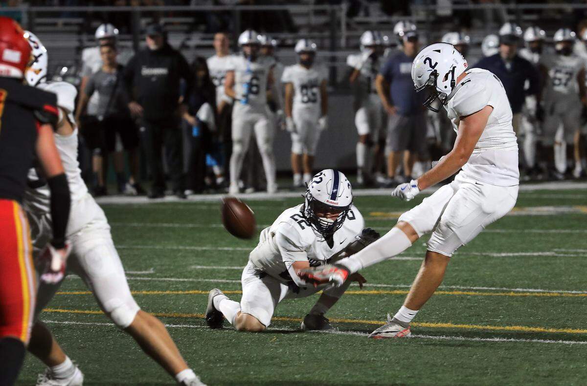 Chiawana's Morgan Dodson (2) kicks a PAT from the hold of teammate Tayten Cissne (22) during their Sept. 12, 2024 game against Kamiakin at Lampson Stadium in Kennewick.
