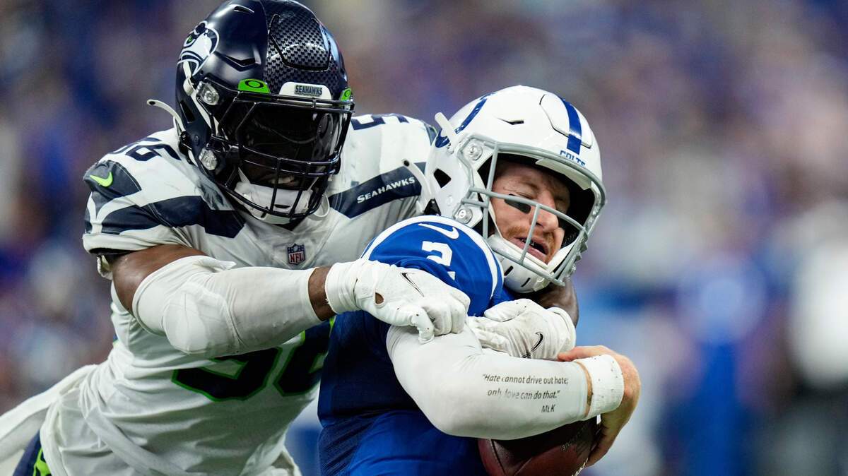 Seattle Seahawks linebacker Jordyn Brooks (56) sacks Indianapolis Colts quarterback Carson Wentz (2) during the second half of an NFL football game in Indianapolis, Sunday, Sept. 12, 2021. (AP Photo/AJ Mast)