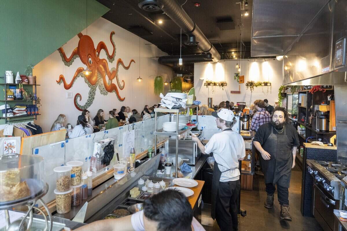 Three Hearts staff move behind the counter to fulfill orders on Friday, Jan. 23, 2026, in Tacoma, Wash.