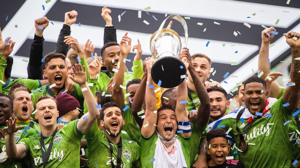 Seattle Sounders midfielder Nicolas Lodeiro (10) and the Seattle Sounders hoist the MLS cup after the match. The Seattle Sounders FC played Toronto FC during the MLS Cup at CenturyLink Field in Seattle, Wash., on Sunday, Nov. 10, 2019.