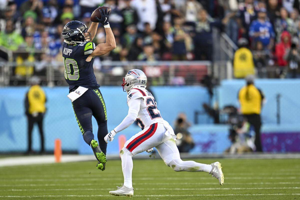 Seattle Seahawks wide receiver Cooper Kupp (10) catches a pass from quarterback Sam Darnold (14) as New England Patriots cornerback Marcus Jones (25) looks on during the second quarter of Super Bowl LX at Levi's Stadium on Feb. 8, 2026 in Santa Clara, Calif.