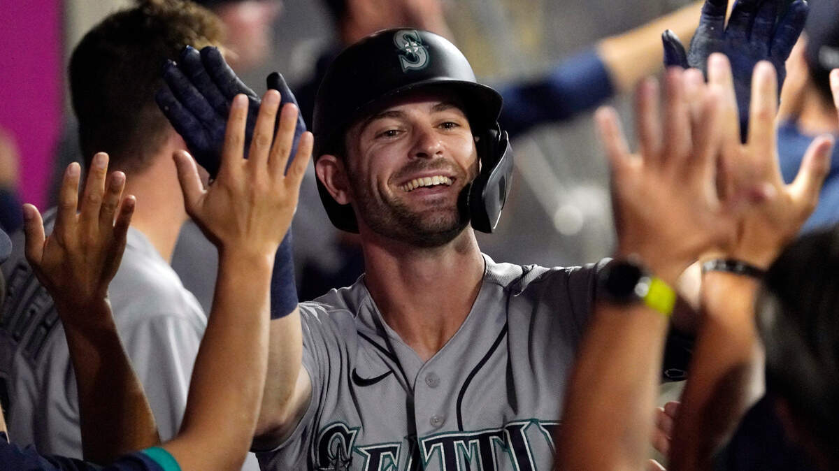 Seattle Mariners’ Mitch Haniger is congratulated by teammates after hitting a two-run home run during the seventh inning of a baseball game against the Los Angeles Angels Friday, July 16, 2021, in Anaheim, Calif. (AP Photo/Mark J. Terrill)