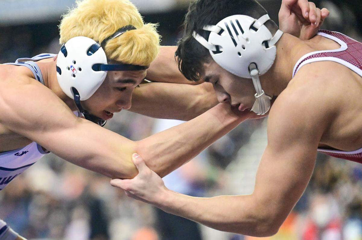 South Kitsap’s Mitchell Neiner (left) and Chiawana’s Davian Martinez fight for hand position during 126-pound 4A semifinal match at Mat Classic XXXIII on Saturday, Feb. 19, 2022, at the Tacoma Dome in Tacoma, Wash. Neiner won by technical fall.