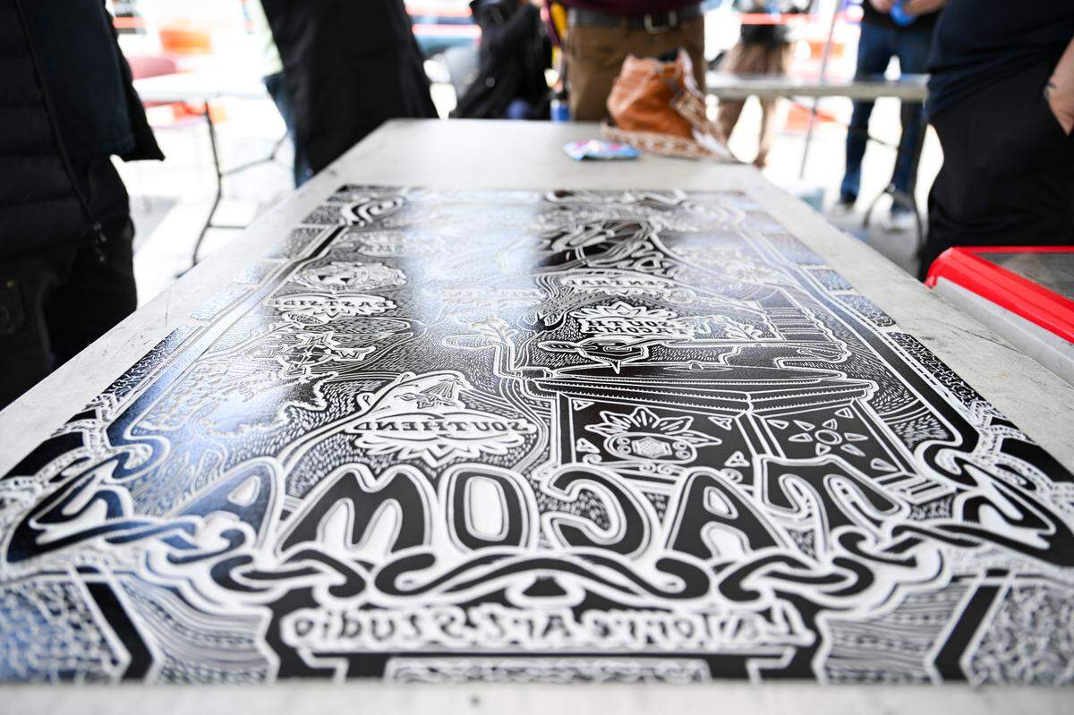 Juan La Torre’s linoleum cut print, that took more than 100 hours to carve out, is inked and ready to be pressed with a steamroller during the Wayzgoose printmaking festival at the Tacoma Public Library, on Friday, May 2, 2025, in Tacoma.