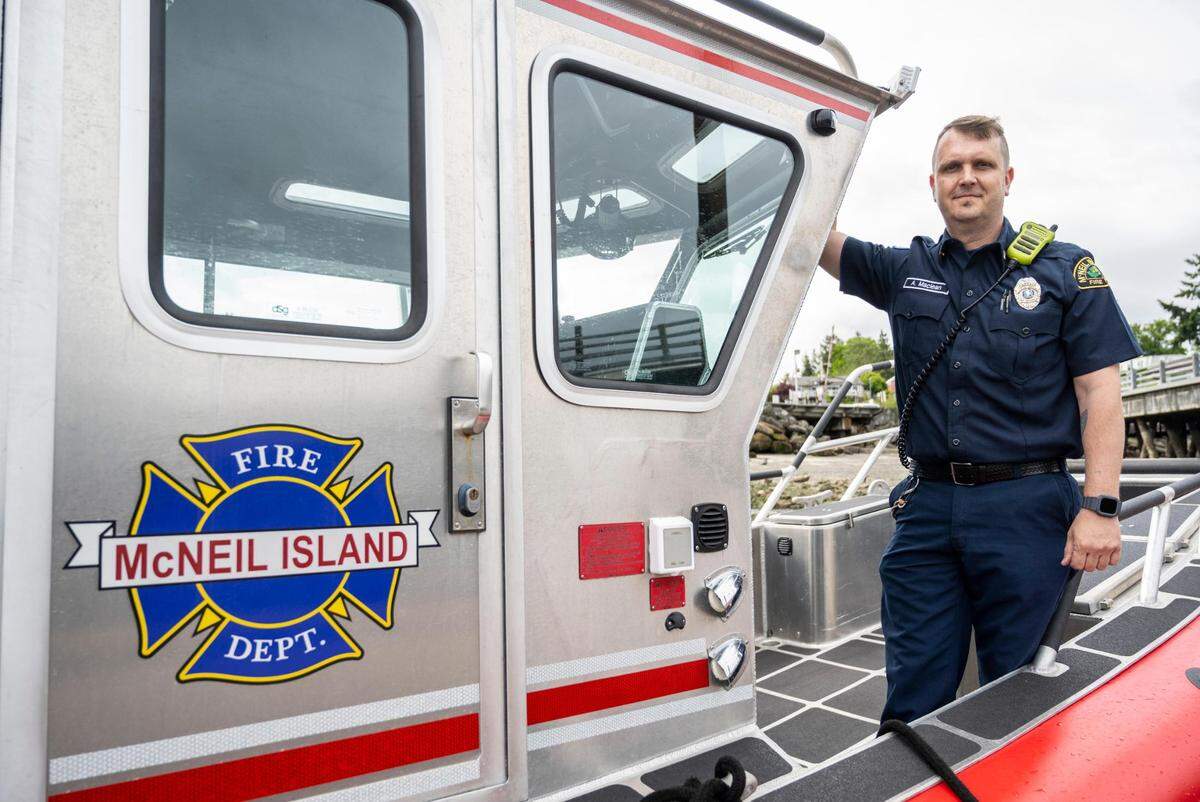McNeil Island Fire Department Captain Aaron MacLean poses for a portrait on the boat that he and other firefighters used to rescue two brothers from their sailboat that was stranded in the Puget Sound, on Friday, May 27, 2022 in Steilacoom, Wash.