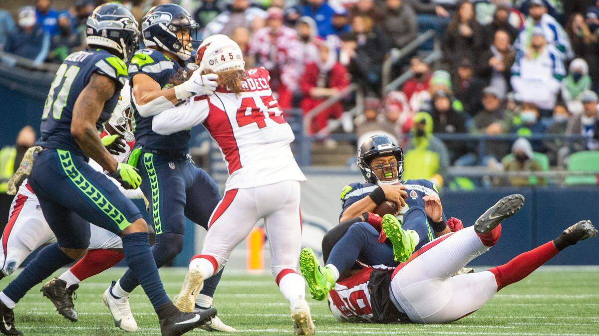 Seattle Seahawks quarterback Russell Wilson (3) is sacked by Arizona Cardinals outside linebacker Chandler Jones (55) in the third quarter of an NFL game on Sunday afternoon at Lumen Field in Seattle.