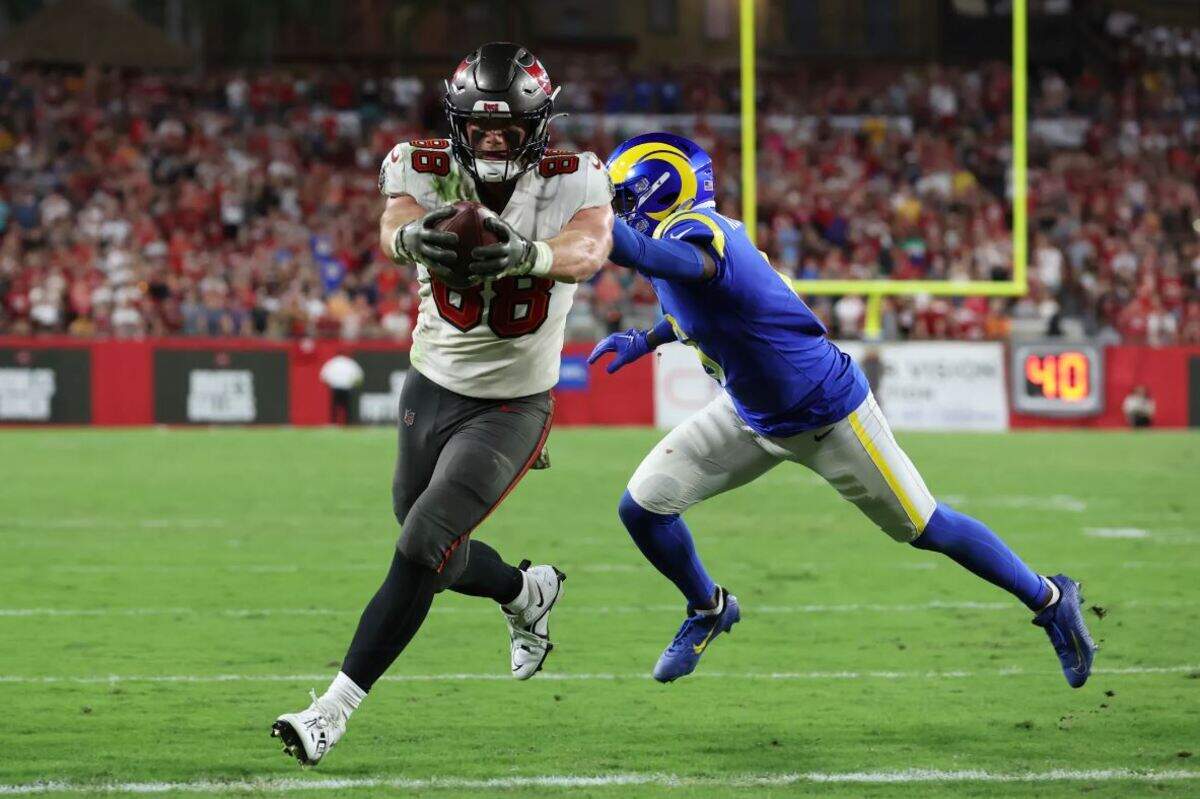Tampa Bay tight end Cade Otton (88) from Tumwater scores on a 1-yard pass from Tom Brady while being defended by Los Angeles Rams cornerback Derion Kendrick (6) and Nick Scott (33) during the second half of an NFL football game between the Los Angeles Rams and Tampa Bay Buccaneers, Sunday, Nov. 6, 2022, in Tampa, Fla.