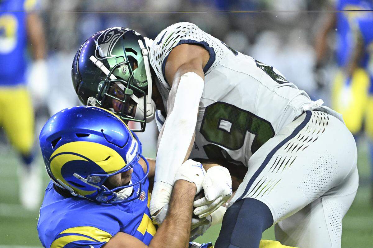 Los Angeles Rams wide receiver Puka Nacua (12) is tackled by Seattle Seahawks cornerback Josh Jobe (29) in the first quarter of the game at Lumen Field, on Thursday, Dec. 18, 2025, in Seattle.