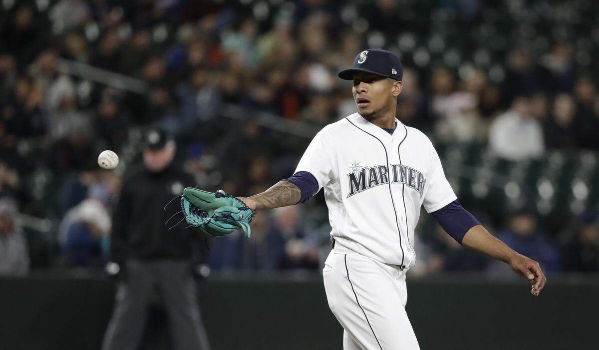 Seattle Mariners starting pitcher Ariel Miranda reaches for a ball against the Houston Astros in the first inning of a baseball game Tuesday, April 17, 2018, in Seattle. (AP Photo/Elaine Thompson)