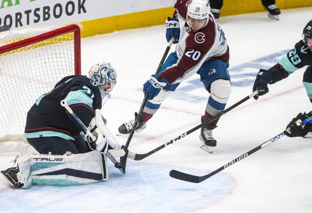 Seattle Kraken goaltender Philipp Grubauer (31) blocks the puck as Colorado Avalanche center Lars Eller (20) tries to score during the first period of a first round 2023 Stanley Cup Playoffs game at Climate Pledge Arena in Seattle on Monday, April 24, 2023.