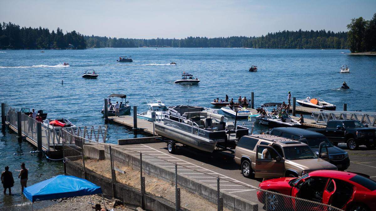 People unload their boats and other watercraft at the American Lake boat launch in Lakewood, Wash., on Sunday, Aug. 16, 2020.