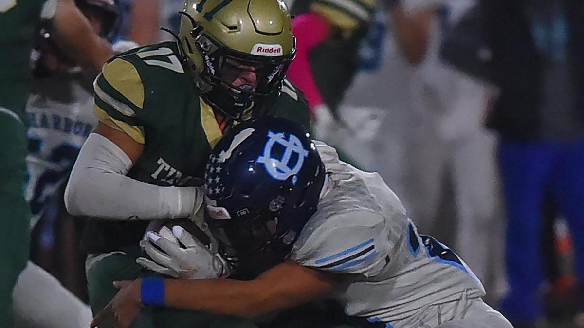 Timberline RB Kaleb McNeely takes a shot from Gig HarborÕs Rylen Lopes on Oct. 22, 2021 at South Sound Stadium in Lacey with 3A playoff positioning implications on the line.