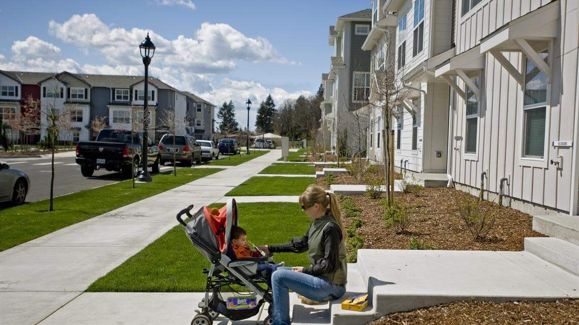 Tatiana Robles and her son Anton sit on her stoop in the newly-built Town Center housing development on Joint Base Lewis McChord in 2011. Recent problems with on-base housing across the country have caught the attention of U.S. senators.
