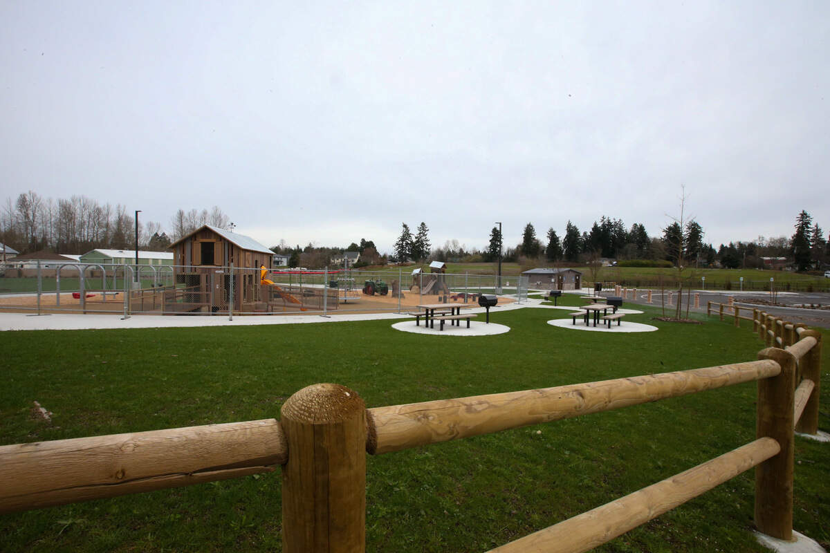 The Edgewood Community Park has a playground with synthetic surfacing as well as a barn-like play area that has a classic tractor.